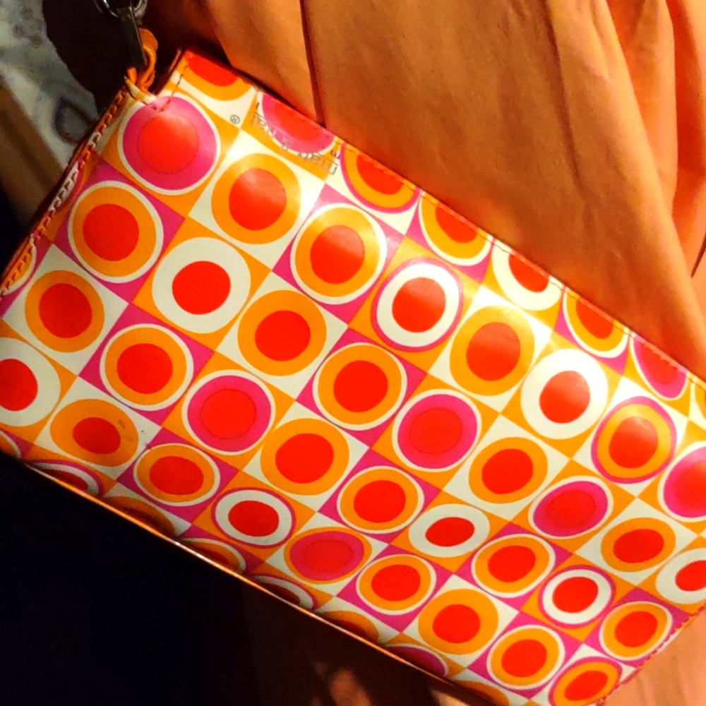 Matt and Natt small polka dot orange clutch has a strape to put on shoulder.al n